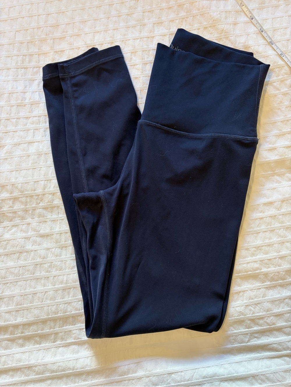 QUINCE- size small high-waisted activewear leggings in a deep navy color,